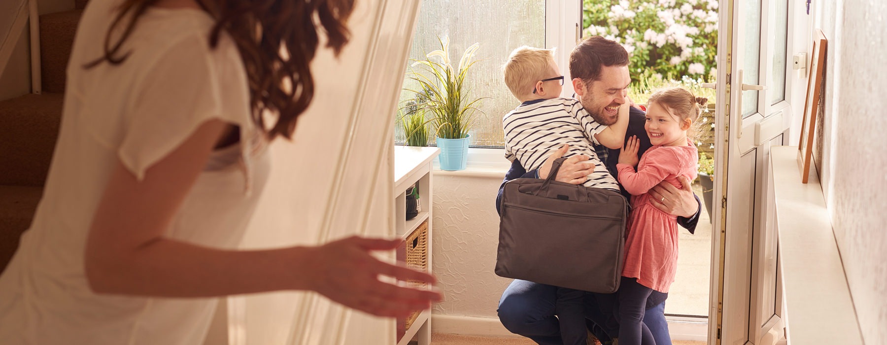 man hugging kids