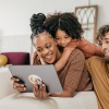 parents look at a tablet with their child