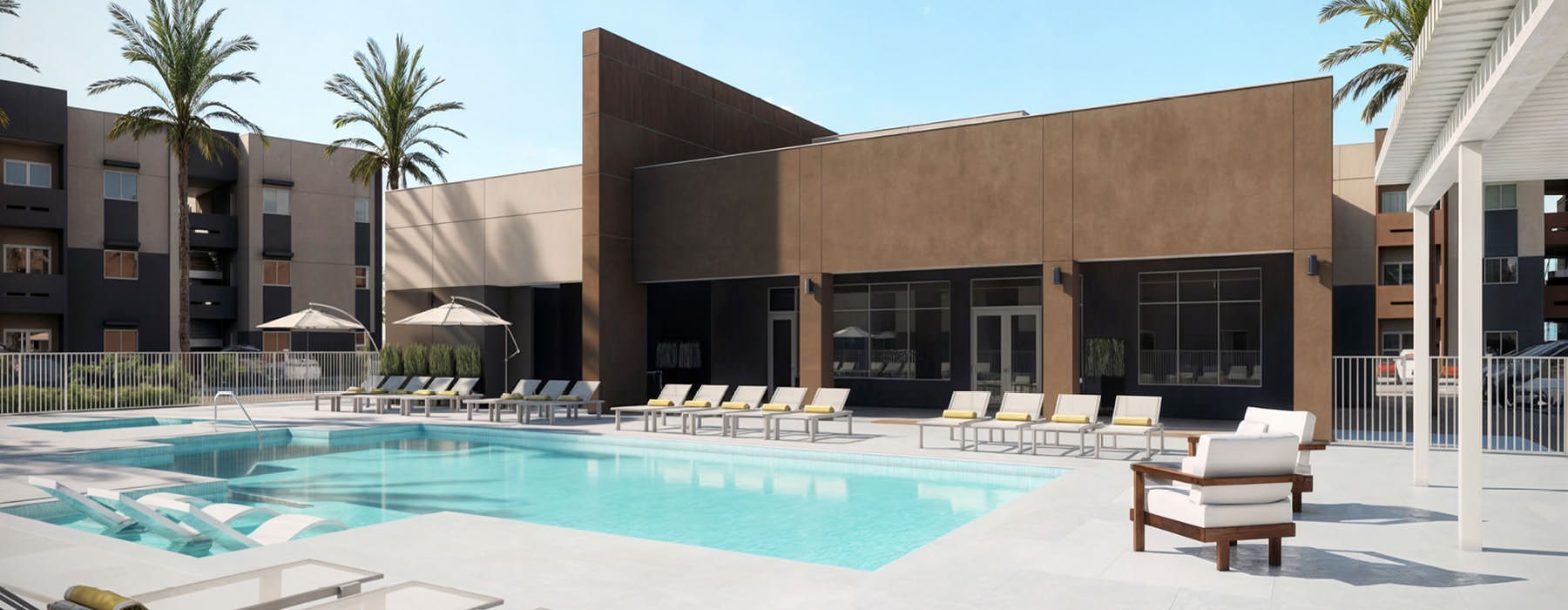 a swimming pool in front of a building with palm trees